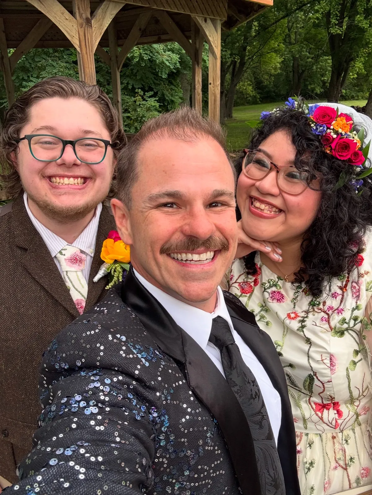 Wedding officiant selfie with couple at outdoor park ceremony